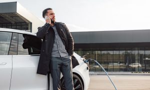 Mladý muž dobíja svoj elektromobil